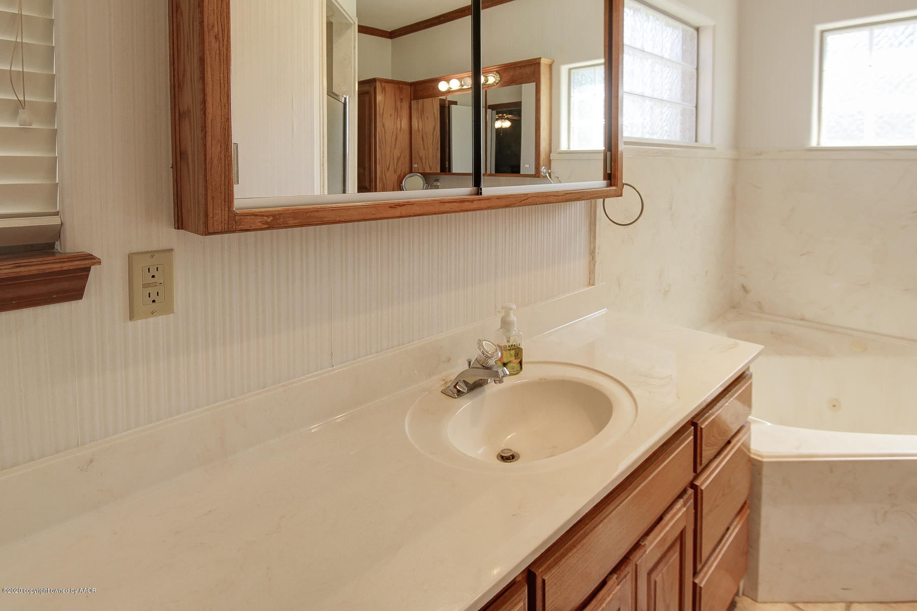 9000 Red Wing Road Amarillo, TX 79119 - Photo 28 of 33 a bathroom with a sink and a mirror