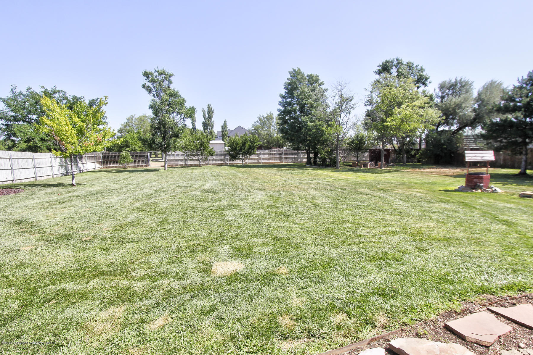 9000 Red Wing Road Amarillo, TX 79119 - Photo 31 of 33 a backyard of a house with lots of green space and fountain