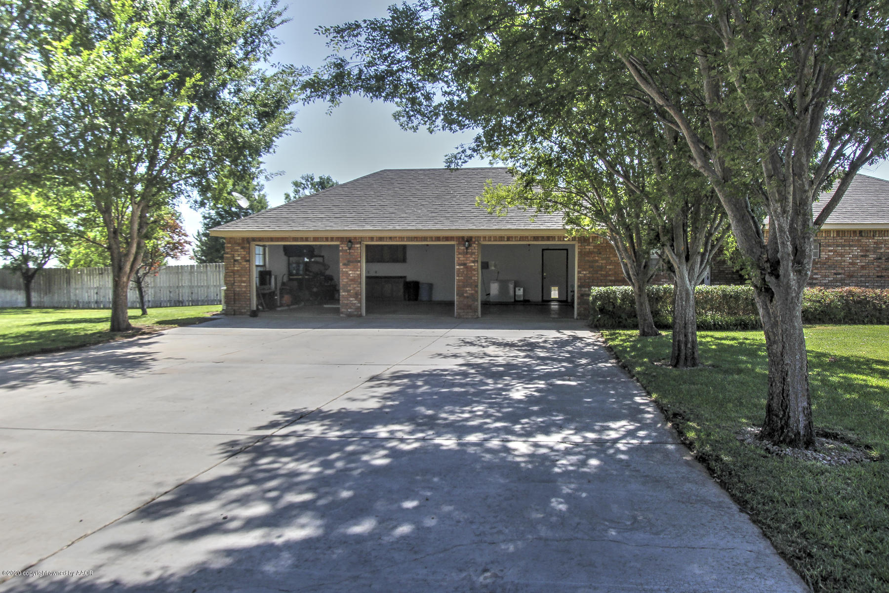 9000 Red Wing Road Amarillo, TX 79119 - Photo 7 of 33 a front view of a house with a garden