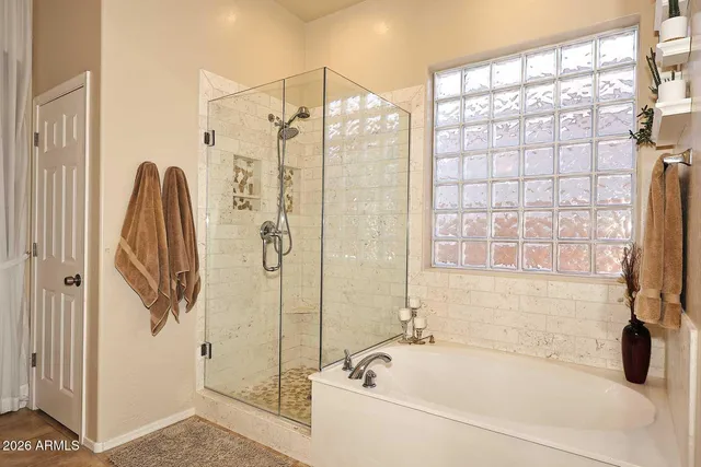 a dining room with glass top table and chairs