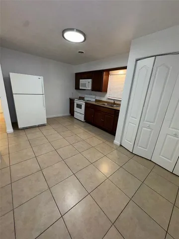 a view of kitchen with microwave and cabinets