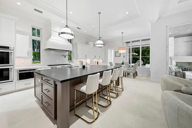 a kitchen with white cabinets and appliances