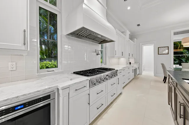 a dining room with furniture a chandelier and wooden floor