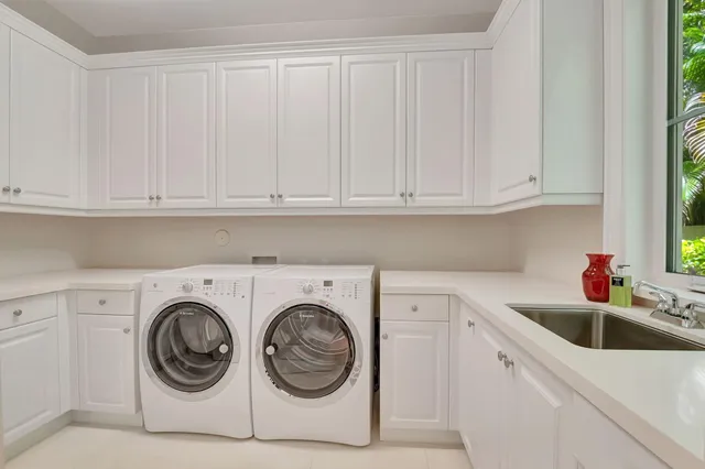 a kitchen with granite countertop a sink a stove and cabinets
