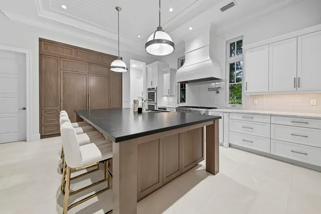 a living room with furniture a large window and a flat screen tv