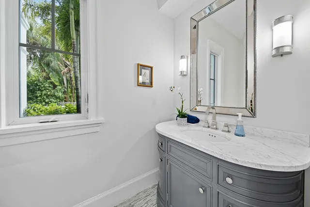 a living room with furniture a window and a chandelier