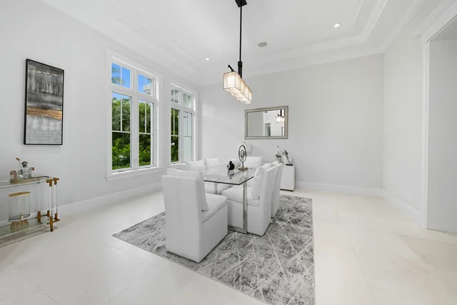 a living room with furniture a rug and white walls