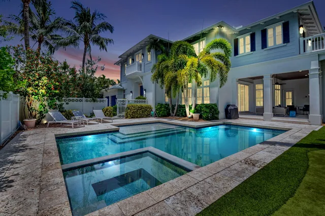 a view of a house with swimming pool and a sitting area