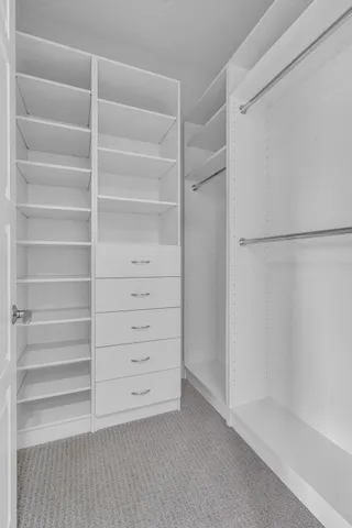 a bathroom with a granite countertop toilet a sink and a mirror