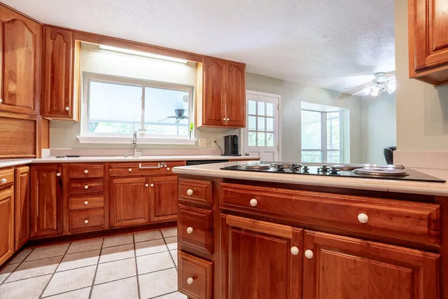 a kitchen with stainless steel appliances sink cabinets and window