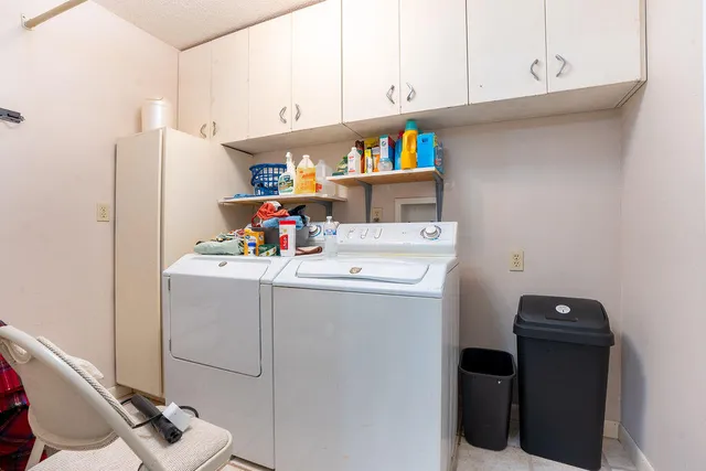a utility room with sink dryer and washer