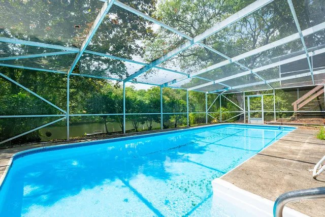 a view of a backyard with a swimming pool