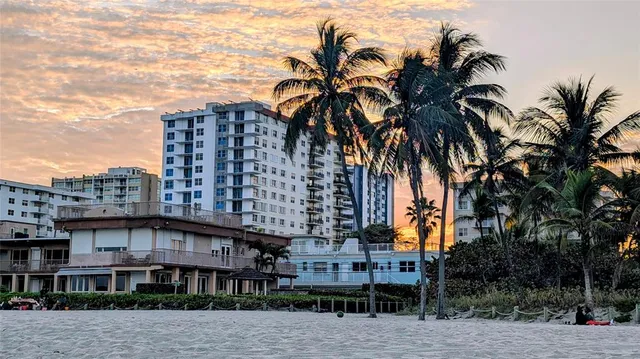 a front view of multi story residential apartment building with sign board