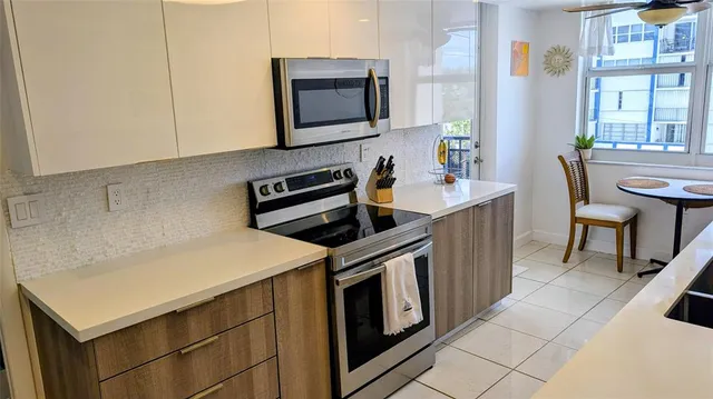 a kitchen with a stove microwave and sink