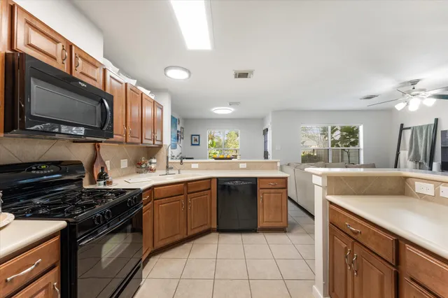 a kitchen with stainless steel appliances granite countertop a sink and stove top oven