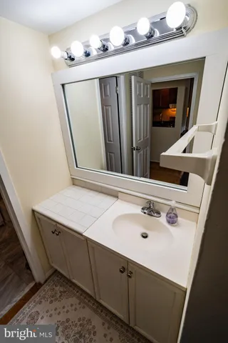 a bathroom with a sink vanity and mirror