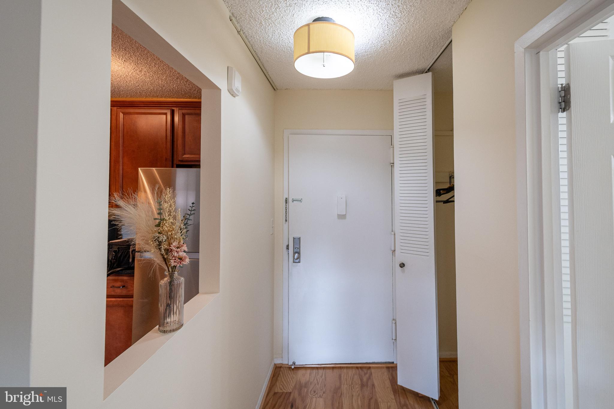 1225 Martha Custis Drive, Unit 502 Alexandria, VA 22302 - Photo 16 of 24 a view of a hallway with wooden floor