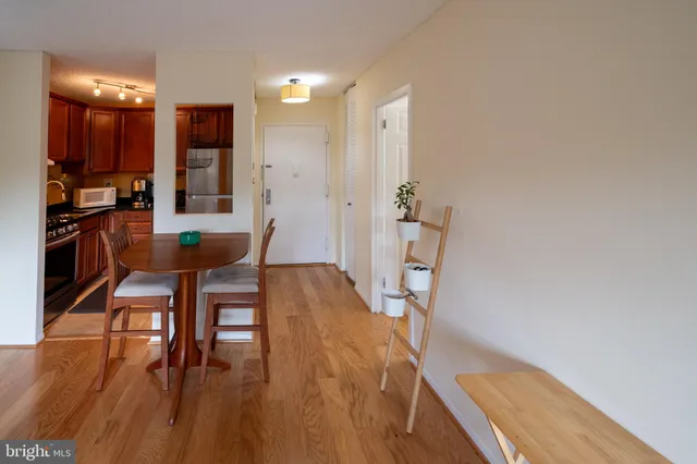 a dining room with furniture and wooden floor