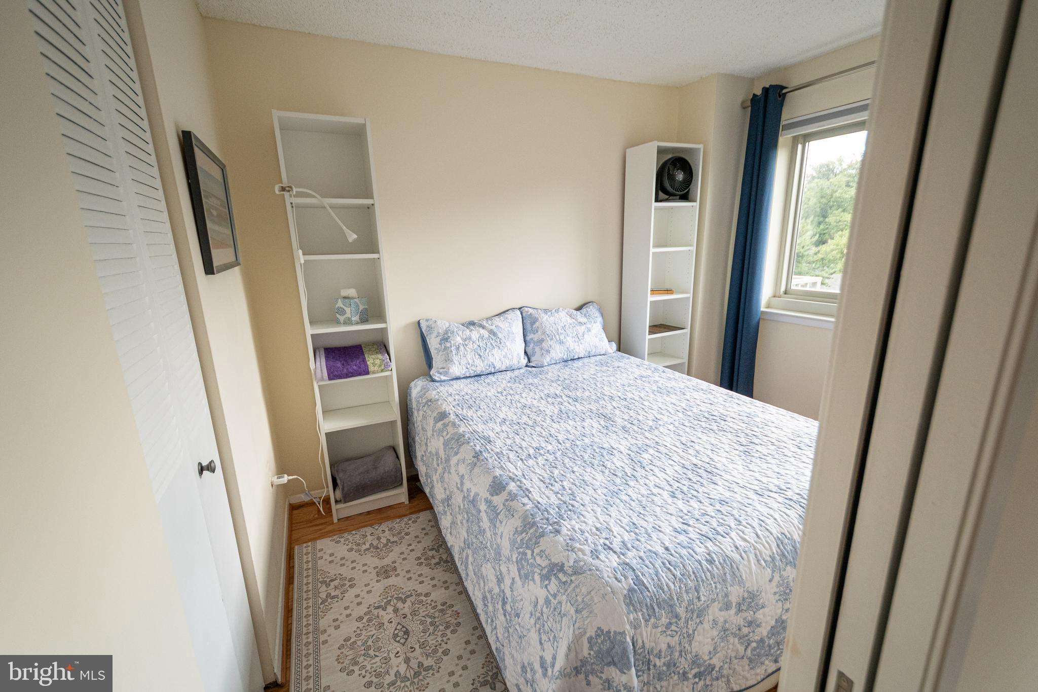 1225 Martha Custis Drive, Unit 502 Alexandria, VA 22302 - Photo 9 of 24 a bedroom with a bed and a mirror
