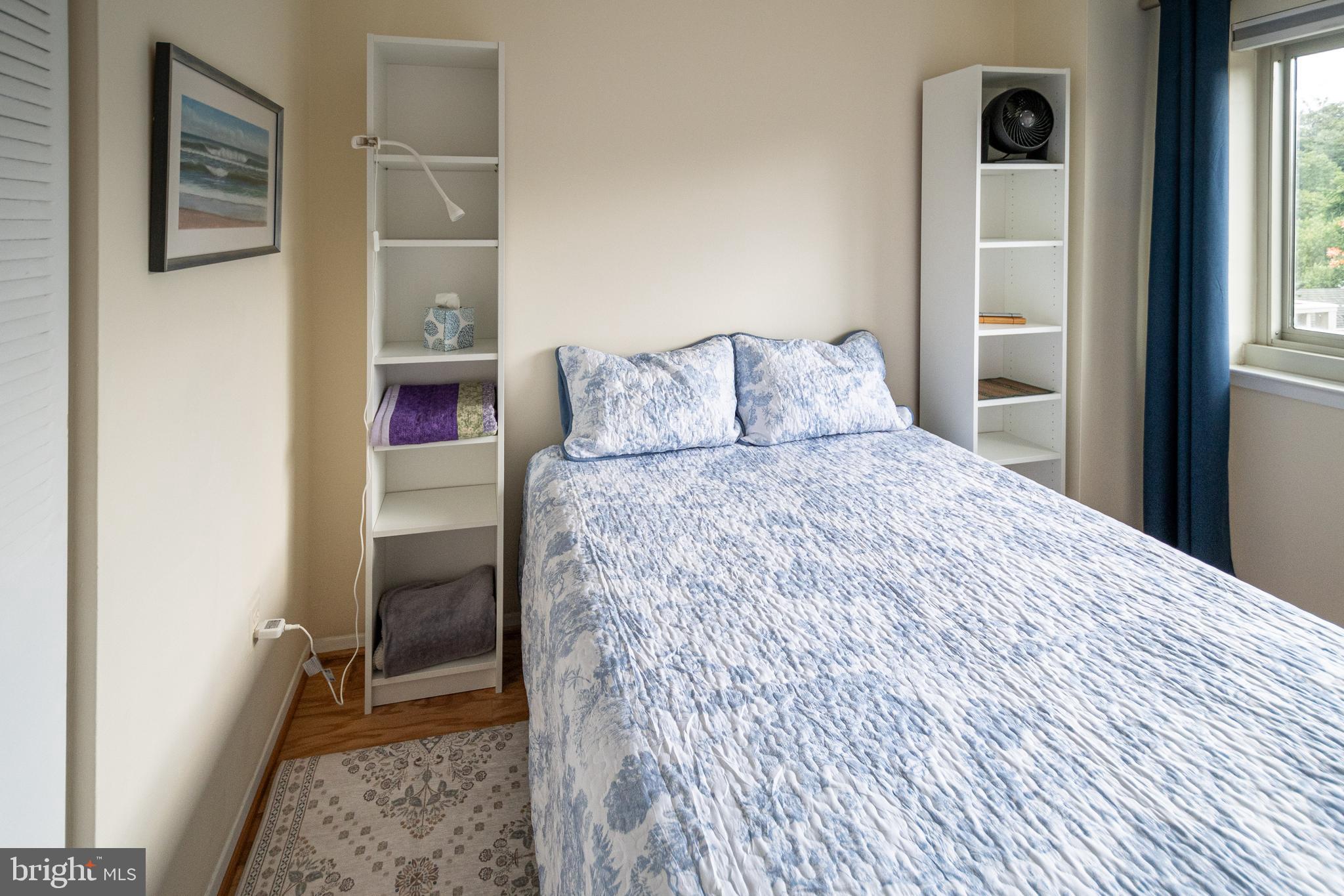 1225 Martha Custis Drive, Unit 502 Alexandria, VA 22302 - Photo 10 of 24 a bedroom with a bed and a window