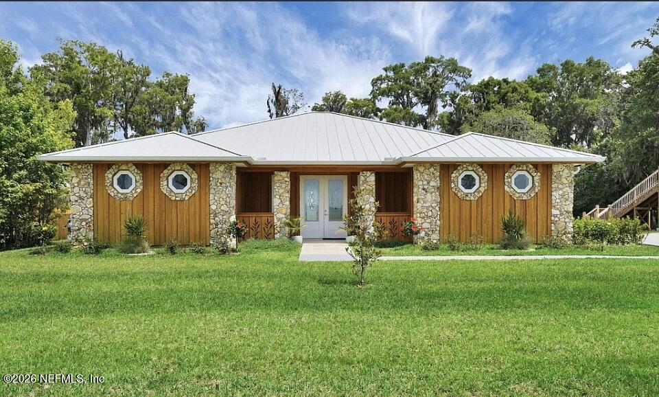 159 Mays Cove Road East Palatka, FL 32131 - Photo 2 of 49 a front view of a house with a garden
