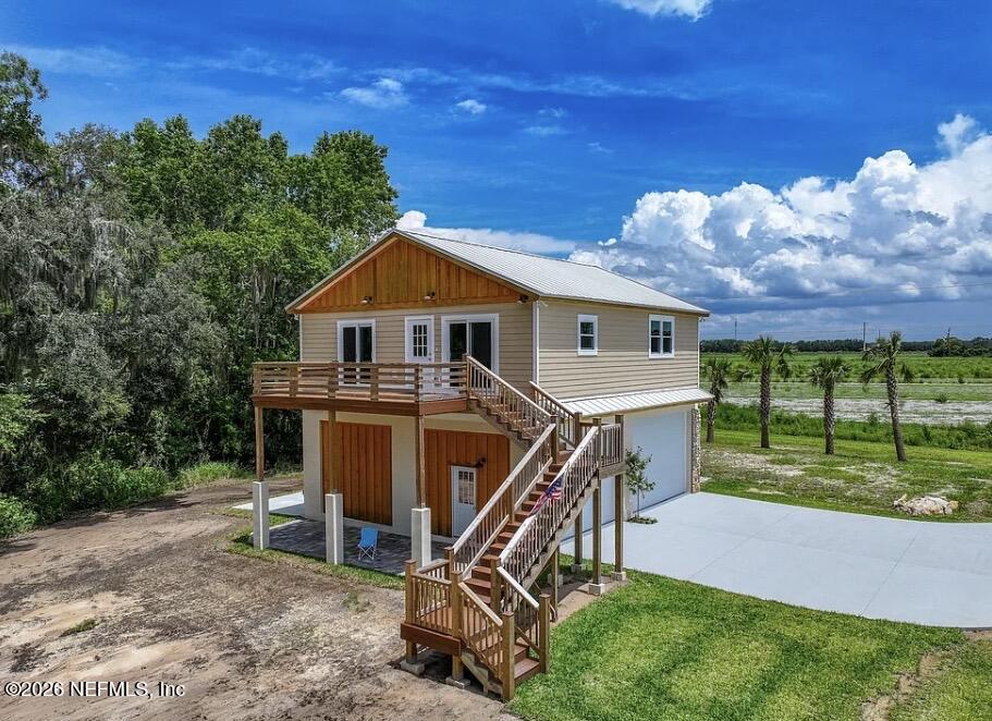 159 Mays Cove Road East Palatka, FL 32131 - Photo 3 of 49 a view of a house with a yard patio and a garden