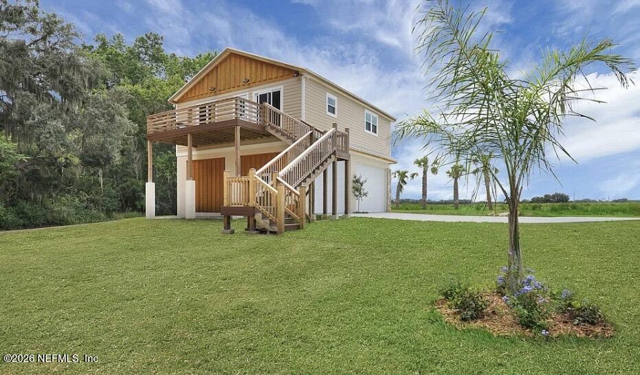 159 Mays Cove Road East Palatka, FL 32131 - Photo 36 of 49 a view of a house with a big yard and palm trees
