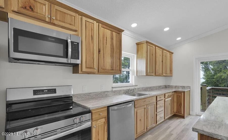 159 Mays Cove Road East Palatka, FL 32131 - Photo 44 of 49 a kitchen with stainless steel appliances granite countertop a stove microwave and cabinets