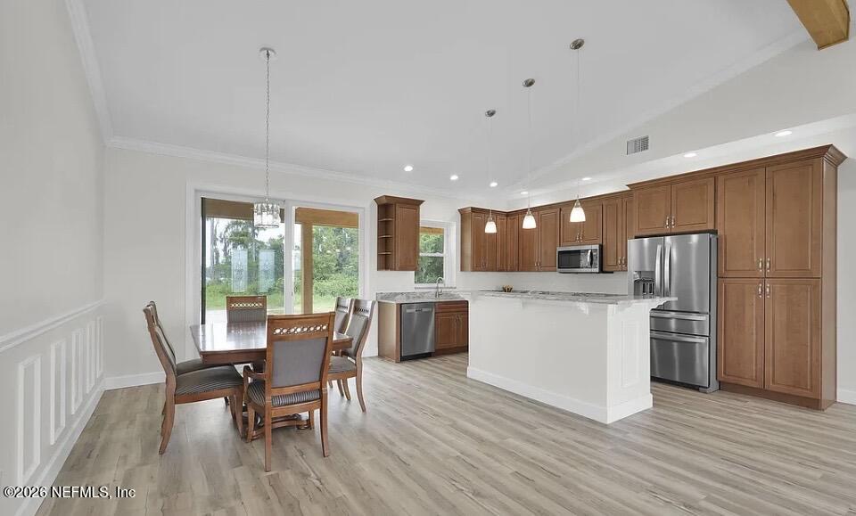 159 Mays Cove Road East Palatka, FL 32131 - Photo 8 of 49 a kitchen with a table chairs wooden floors and a view of living room