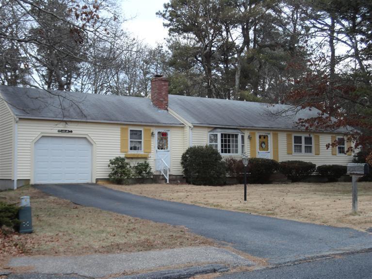 140 Cedric Road Centerville, MA 02632 - Photo 1 of 17 a front view of a house with a yard and garage