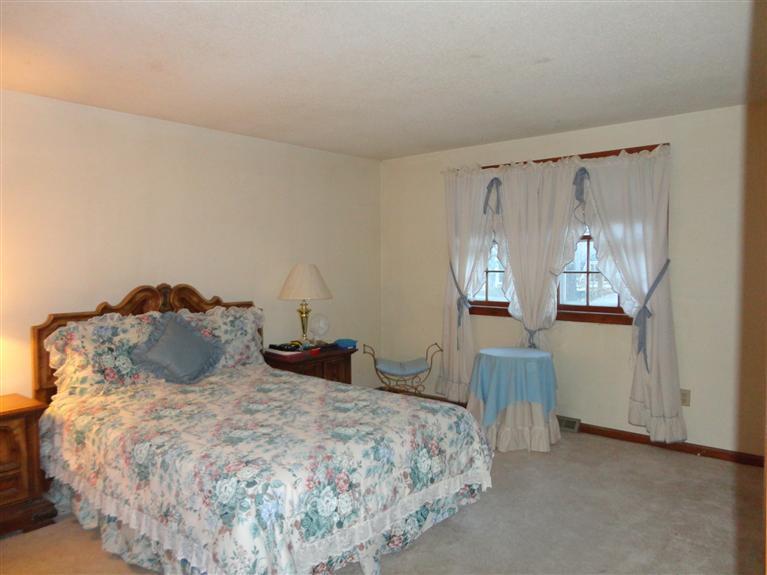 140 Cedric Road Centerville, MA 02632 - Photo 11 of 17 a bedroom with a bed and wooden floor