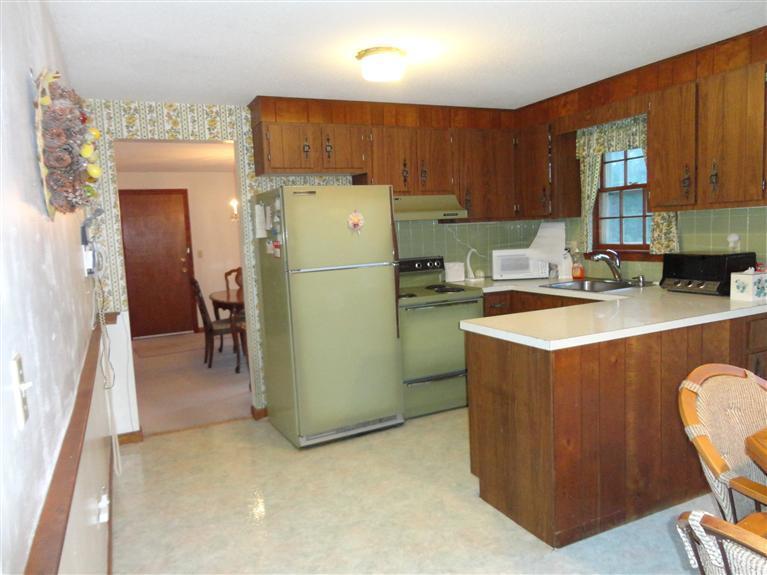 140 Cedric Road Centerville, MA 02632 - Photo 15 of 17 a kitchen with refrigerator a sink a stove and cabinets