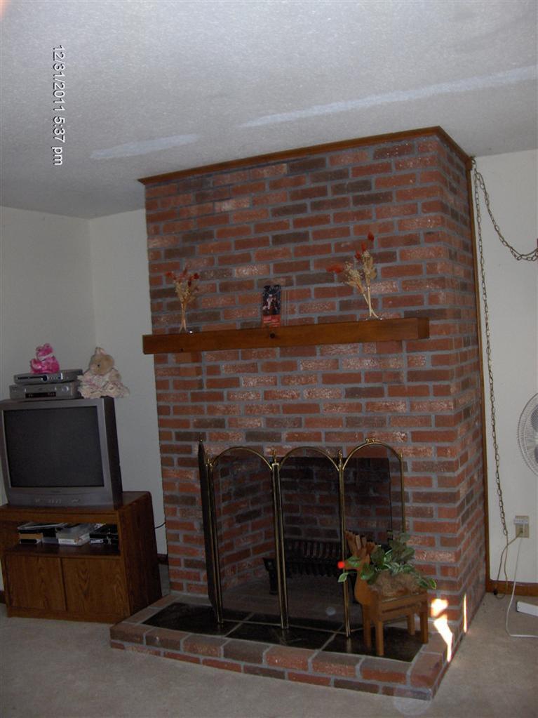 140 Cedric Road Centerville, MA 02632 - Photo 3 of 17 a living room with a fireplace and a flat screen tv