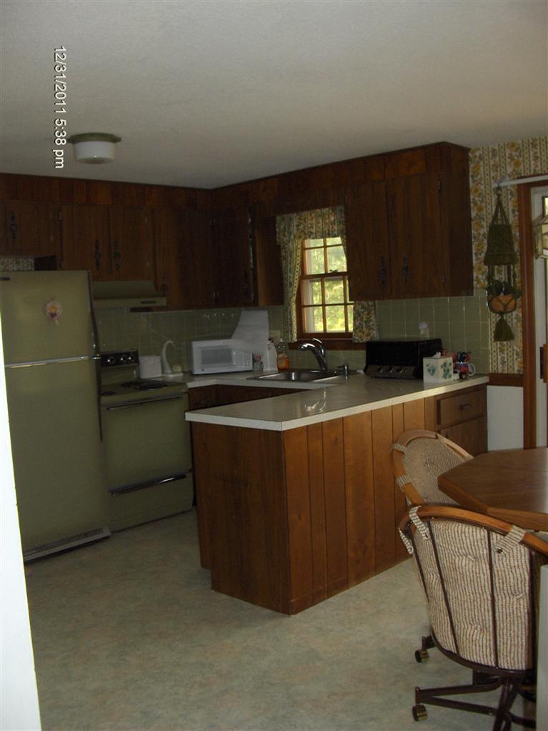 140 Cedric Road Centerville, MA 02632 - Photo 6 of 17 a kitchen with a sink a window and cabinets
