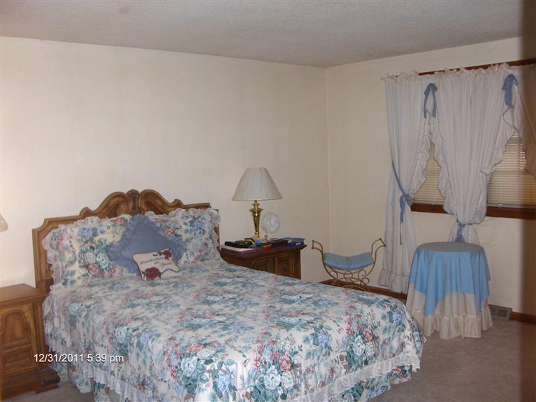 140 Cedric Road Centerville, MA 02632 - Photo 9 of 17 a bedroom with a bed and wooden floor