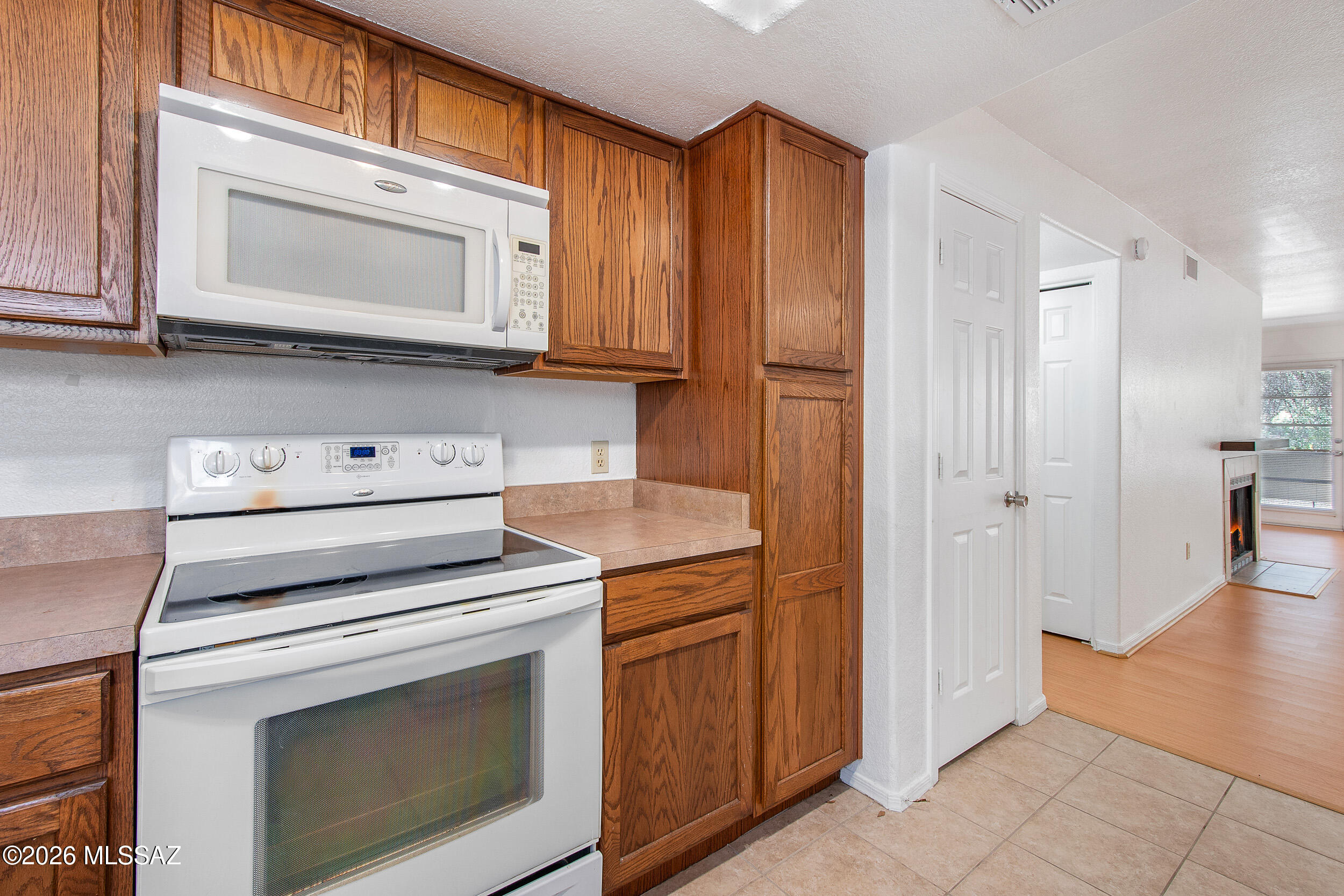 5855 North Kolb Road, Unit 6103 Tucson, AZ 85750 - Photo 10 of 31 a kitchen with white cabinets and a stove top oven