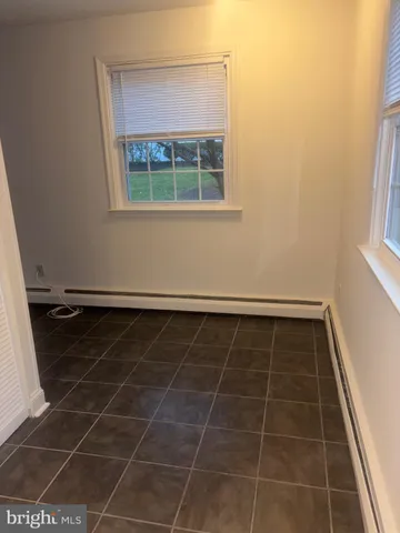 a bathroom with a window and a shower