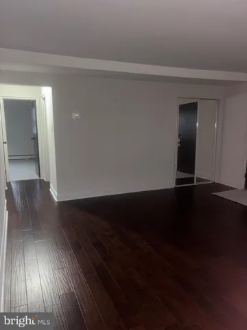 a view of an empty room and wooden floor