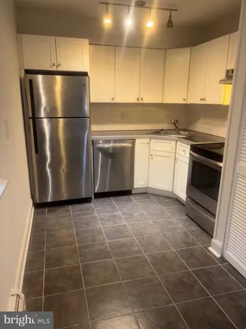 a kitchen with appliances cabinets and a counter top space