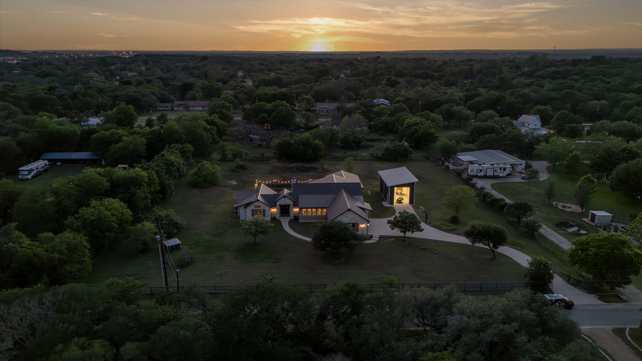 16202 Remuda Trail Buda, TX 78610 - Photo 40 of 40 Aerial view of the property featuring a main residence and an additional structure, set amidst extensive green landscaping