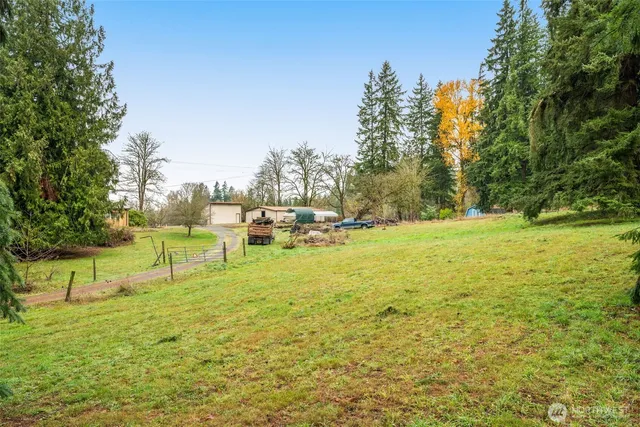a view of yard with swimming pool and trees
