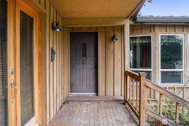 a view of a brick house with wooden floor and a window