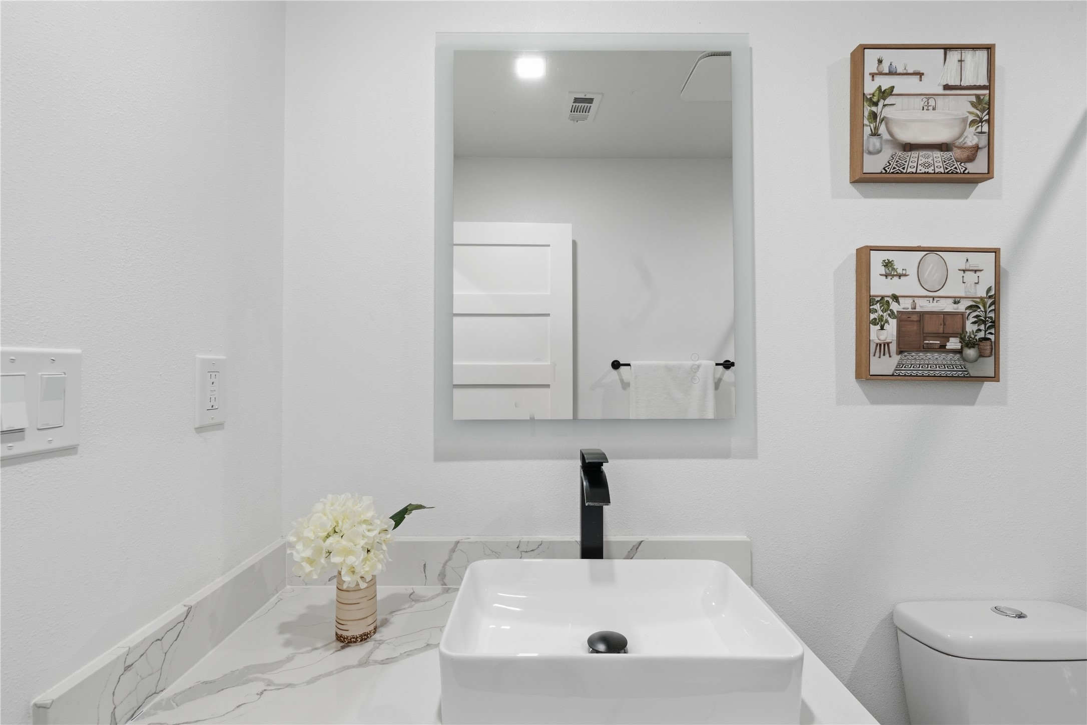 5604 Coventry Lane Austin, TX 78723 - Photo 18 of 33 Modern vanity featuring a rectangular vessel sink, matte black faucet, and a quartz countertop