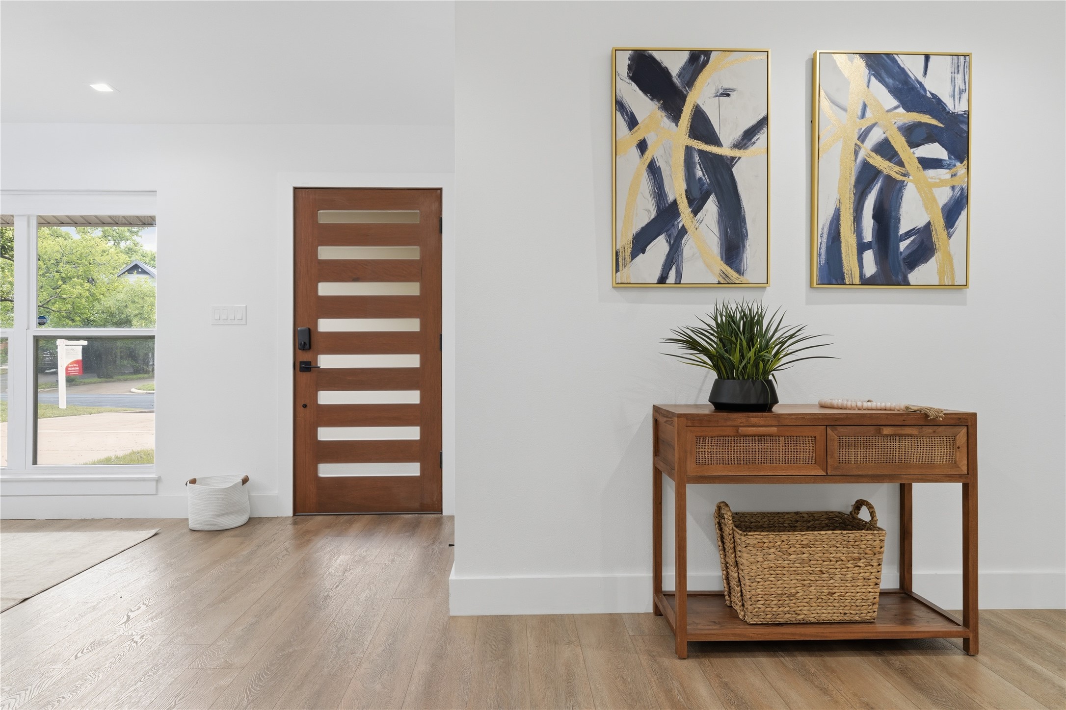 5604 Coventry Lane Austin, TX 78723 - Photo 2 of 33 Modern entry featuring a wood-finish door with frosted glass panels, wood-finish flooring, and a large window with white trim