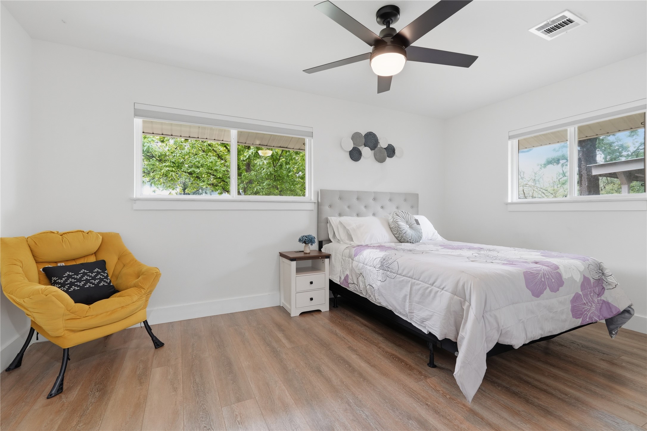 5604 Coventry Lane Austin, TX 78723 - Photo 26 of 33 Spacious room with wood-finish flooring and a contemporary ceiling fan