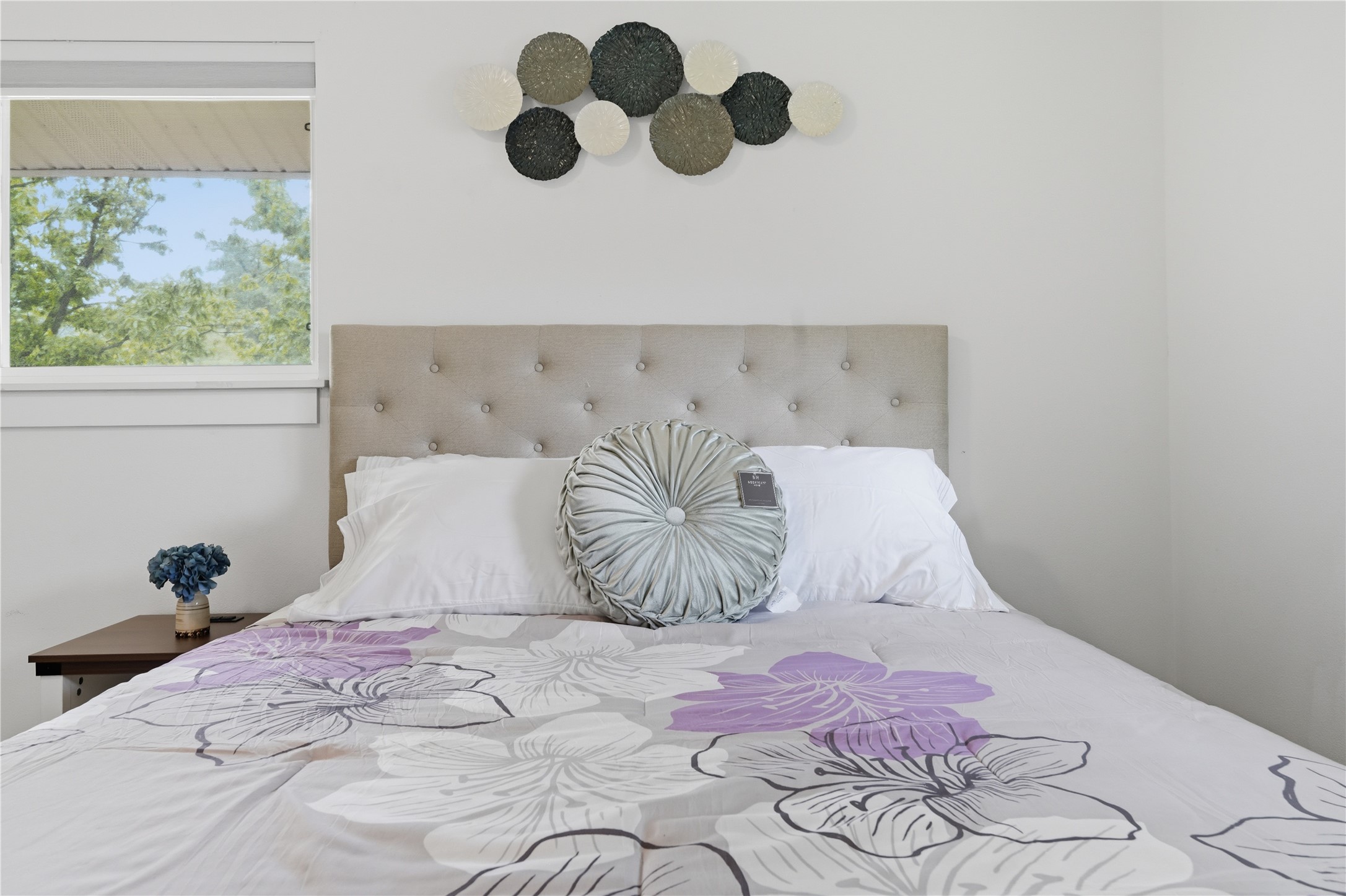 5604 Coventry Lane Austin, TX 78723 - Photo 28 of 33 Tufted upholstered headboard with a light wood-finish side table and a large window