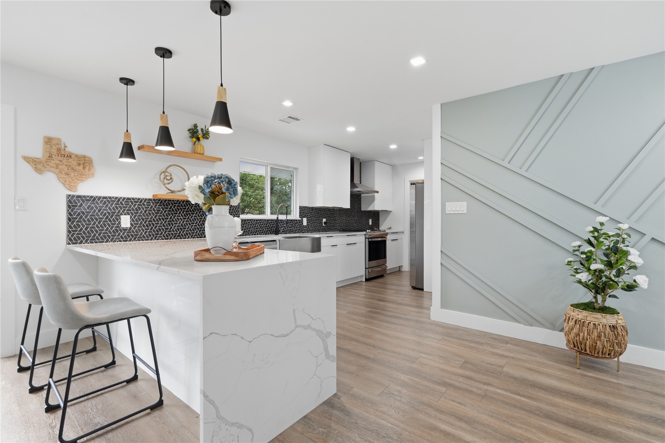 5604 Coventry Lane Austin, TX 78723 - Photo 8 of 33 Kitchen island with waterfall quartz countertop and pendant lighting