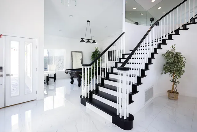 a view of entryway and hall with wooden floor