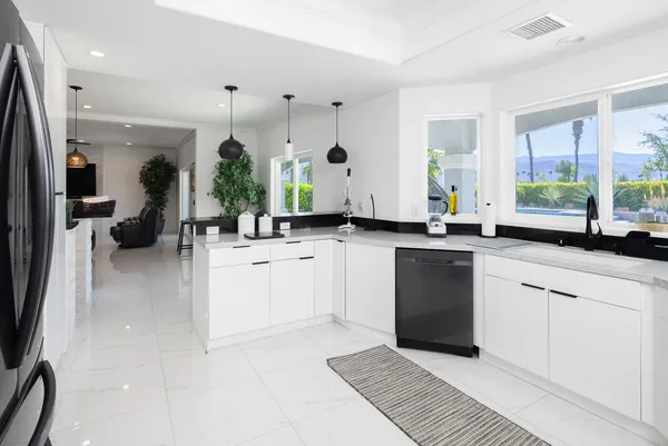 a large white kitchen with a large window