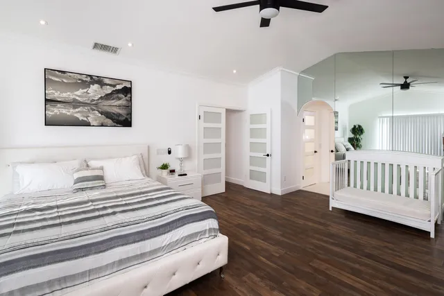a bedroom with furniture and wooden floor